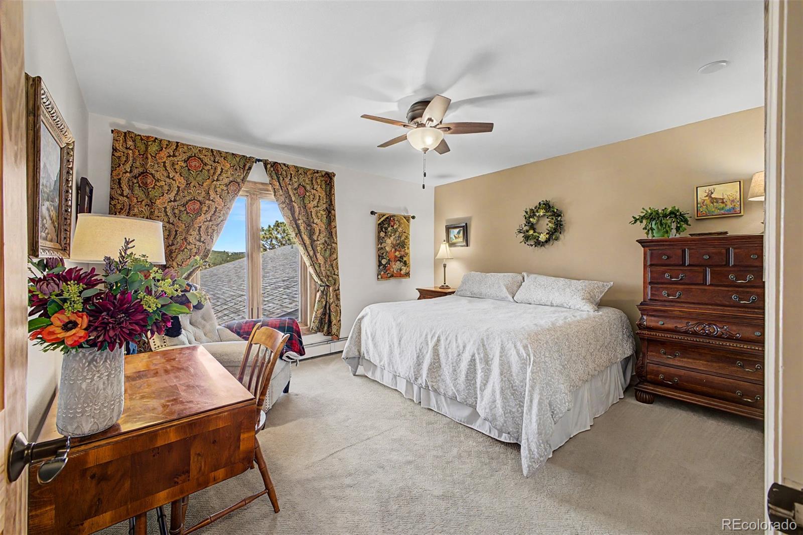 31270 John Wallace Road, Unit 412 Evergreen, CO 80439 - Photo 14 of 38 a bedroom with a bed and a chandelier