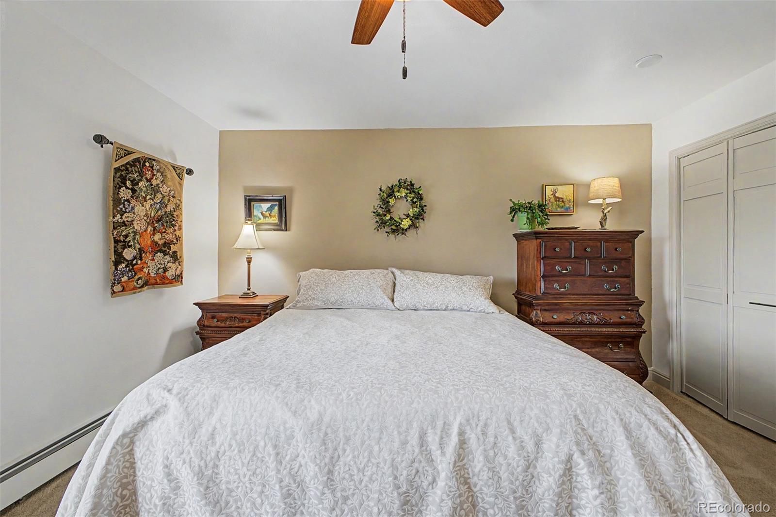 31270 John Wallace Road, Unit 412 Evergreen, CO 80439 - Photo 15 of 38 a bedroom with a bed and painting on the wall