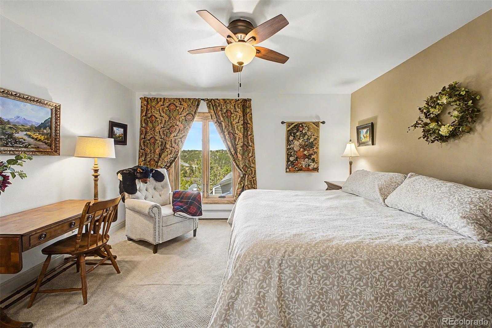 31270 John Wallace Road, Unit 412 Evergreen, CO 80439 - Photo 17 of 38 a bedroom with a bed couch and window