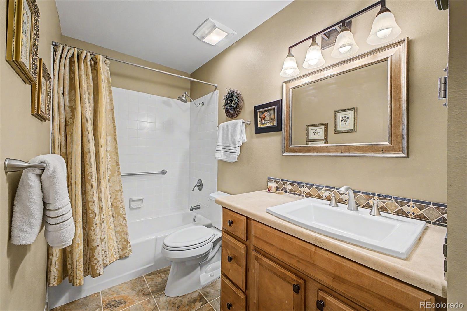 31270 John Wallace Road, Unit 412 Evergreen, CO 80439 - Photo 18 of 38 a bathroom with a sink a toilet and shower