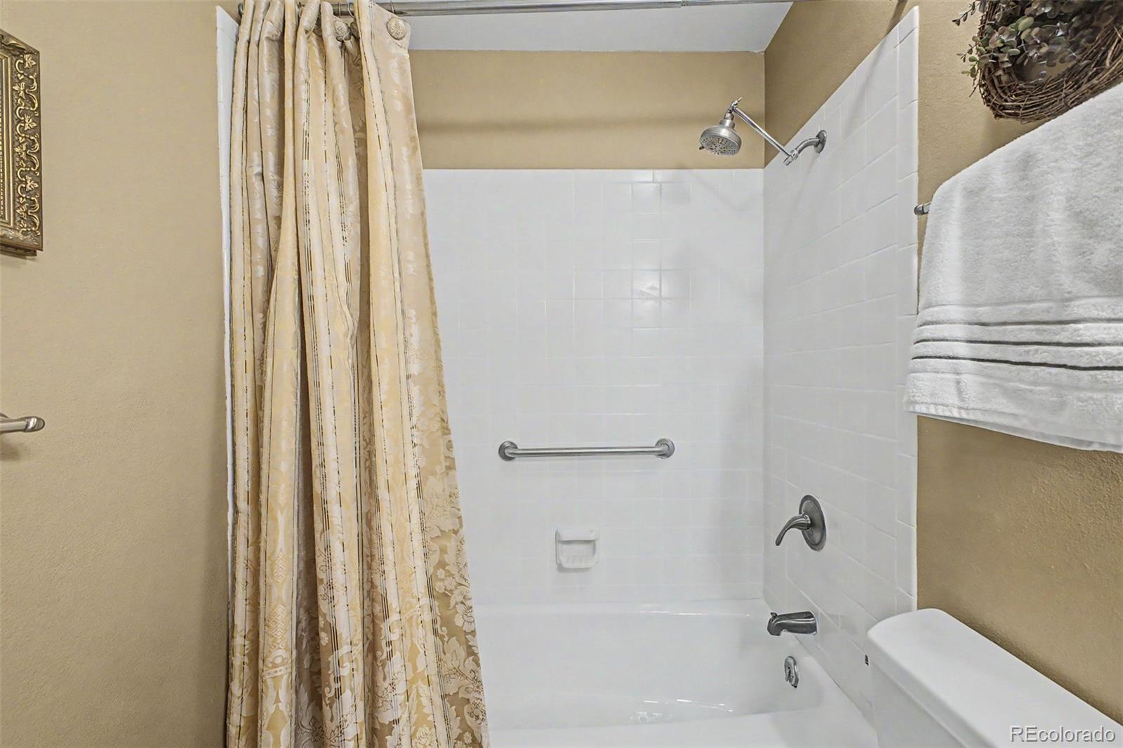 31270 John Wallace Road, Unit 412 Evergreen, CO 80439 - Photo 19 of 38 a bathroom with a bathtub and a shower