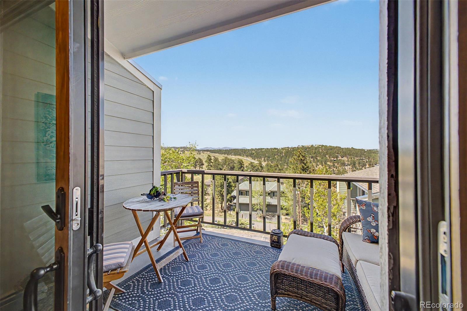 31270 John Wallace Road, Unit 412 Evergreen, CO 80439 - Photo 20 of 38 a balcony with furniture and city view