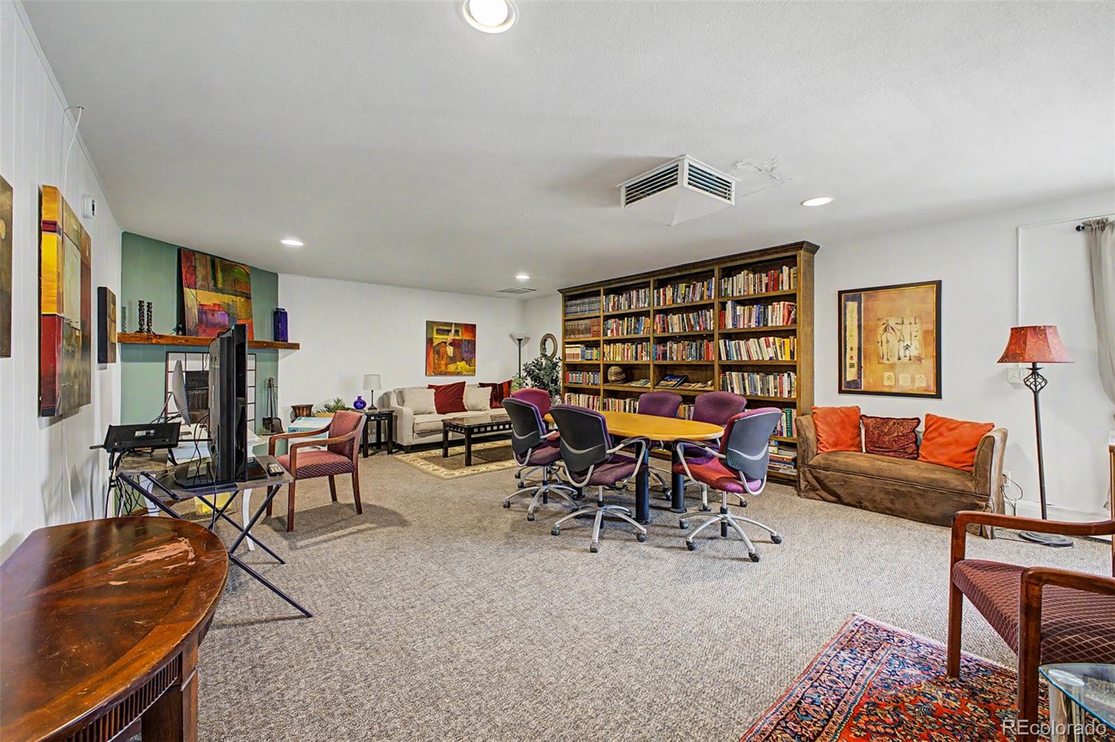 31270 John Wallace Road, Unit 412 Evergreen, CO 80439 - Photo 24 of 38 a living room with furniture a rug and a flat screen tv
