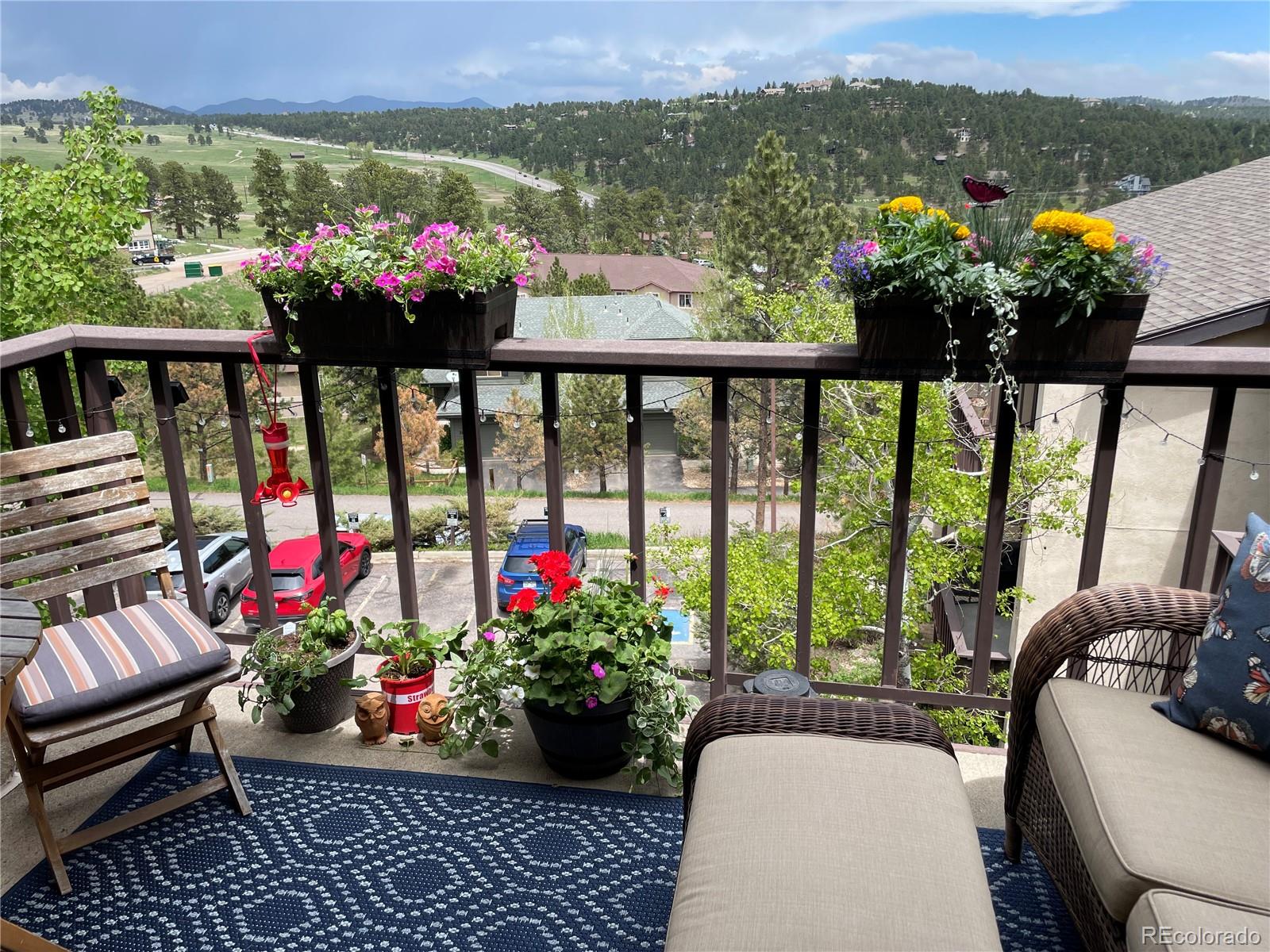 31270 John Wallace Road, Unit 412 Evergreen, CO 80439 - Photo 32 of 38 a view of a chairs and table in patio with a swimming pool