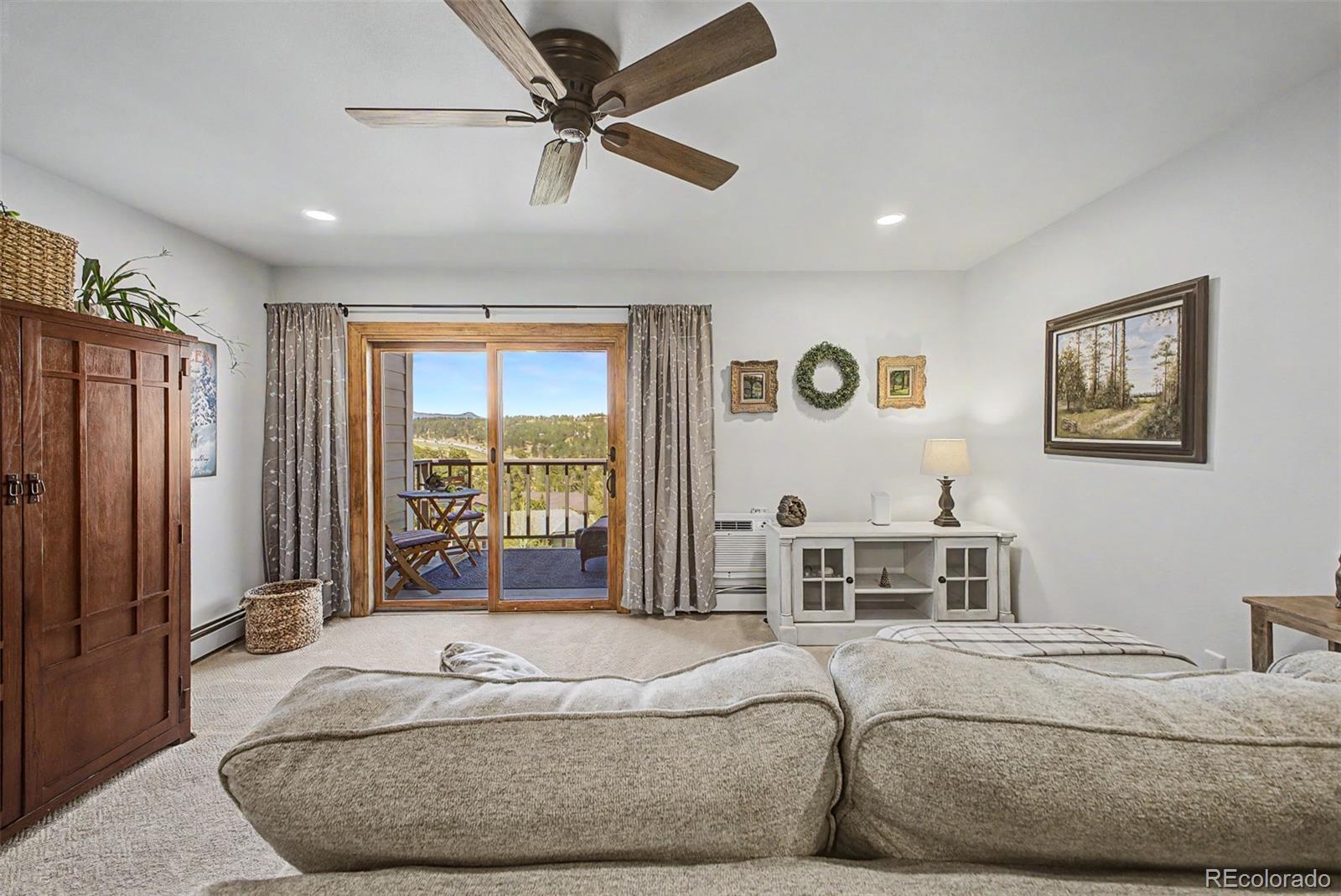 31270 John Wallace Road, Unit 412 Evergreen, CO 80439 - Photo 4 of 38 a bed room with a bed and a large window