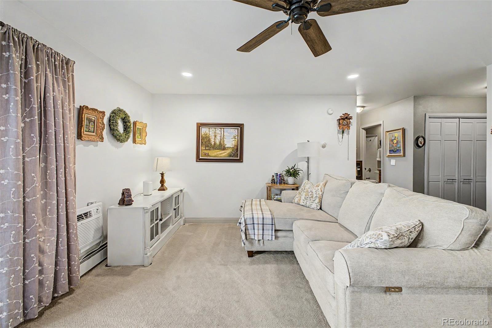 31270 John Wallace Road, Unit 412 Evergreen, CO 80439 - Photo 6 of 38 a living room with furniture and white walls