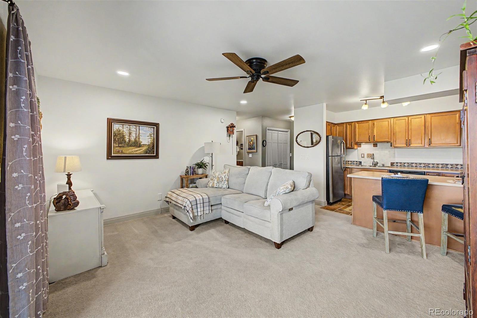 31270 John Wallace Road, Unit 412 Evergreen, CO 80439 - Photo 7 of 38 a living room with furniture and a large window