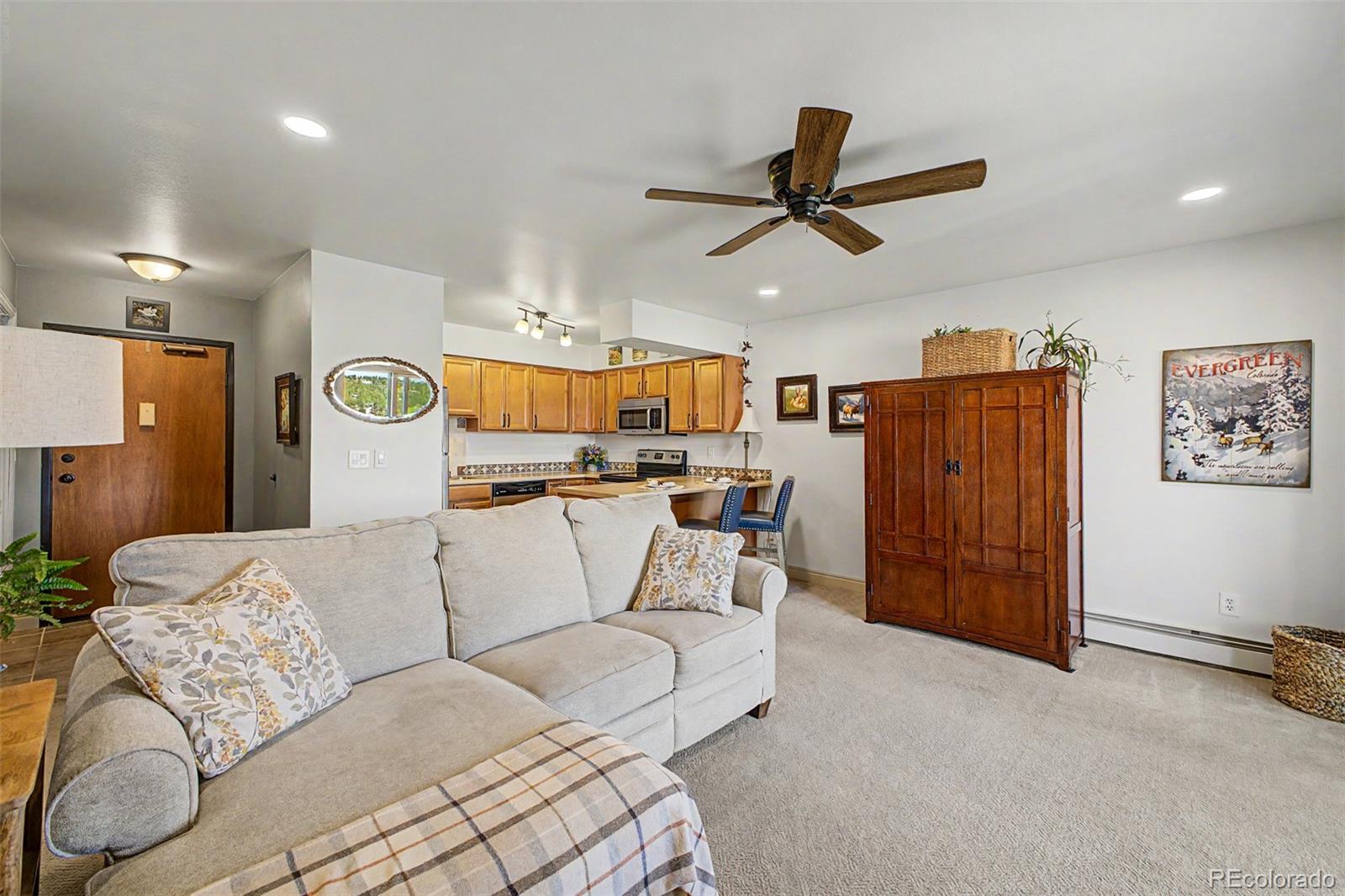 31270 John Wallace Road, Unit 412 Evergreen, CO 80439 - Photo 8 of 38 a living room with furniture and kitchen view