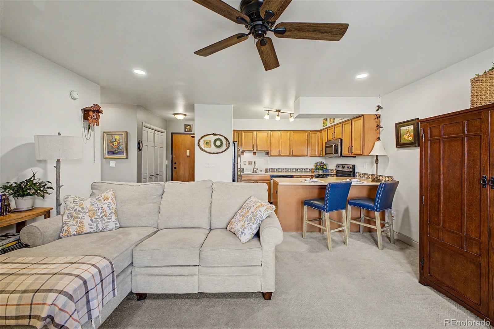 31270 John Wallace Road, Unit 412 Evergreen, CO 80439 - Photo 9 of 38 a living room with furniture and kitchen view