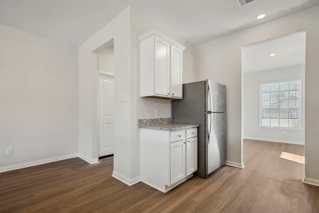 a kitchen with wooden floors and appliances