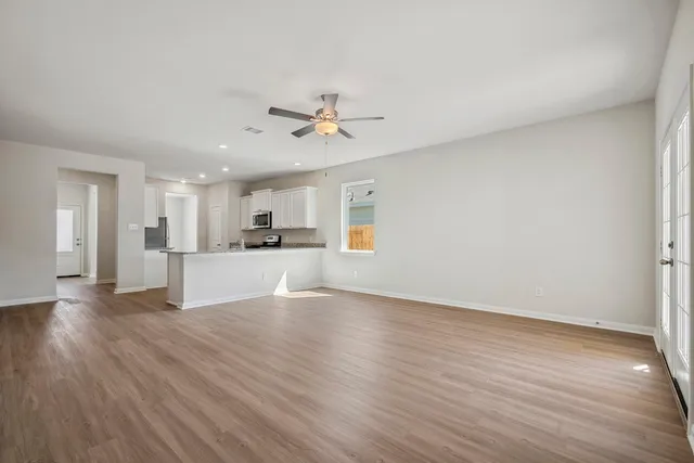 a view of a kitchen with wooden floor and a kitchen