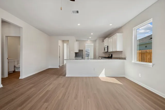 a view of kitchen with wooden floor and electronic appliances