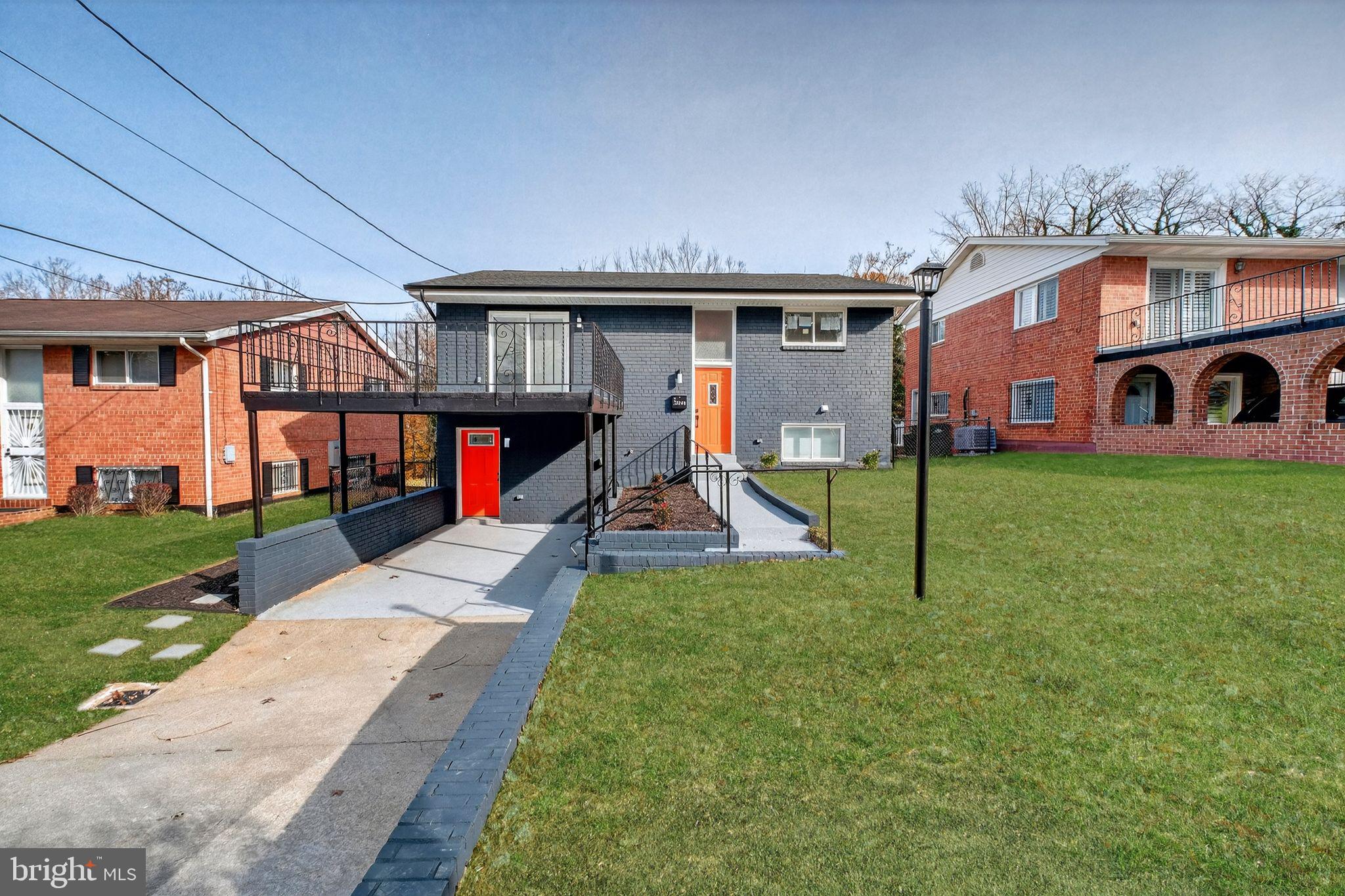 a view of a house with a yard patio and a slide