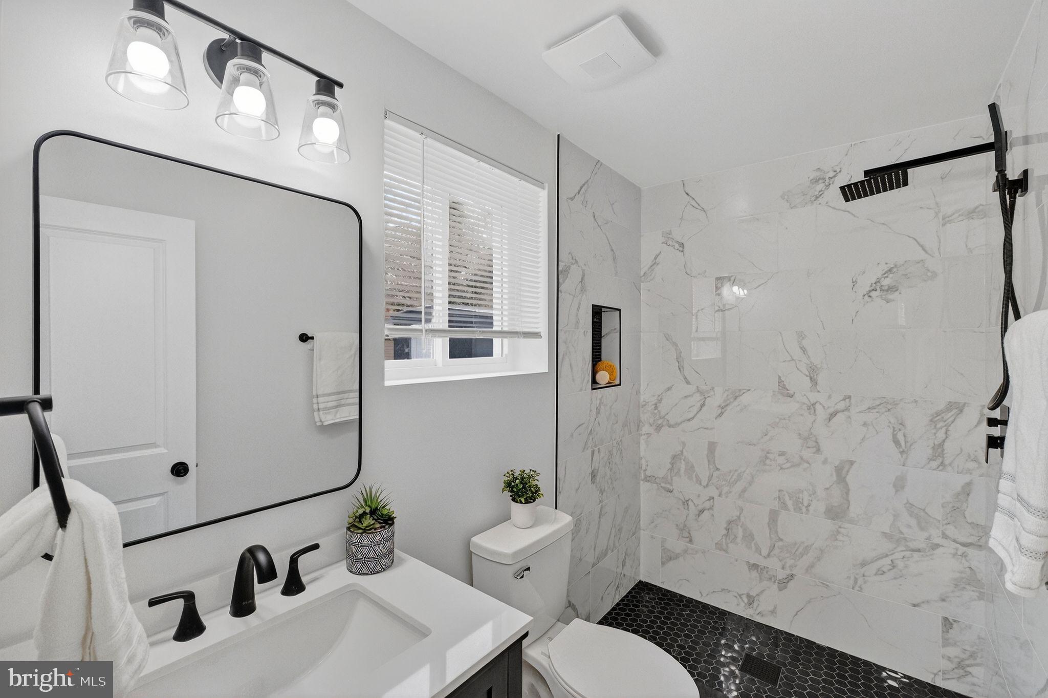 3240 Pope Street Southeast Washington, DC 20020 - Photo 17 of 38 a bathroom with a sink and mirror with bathtub