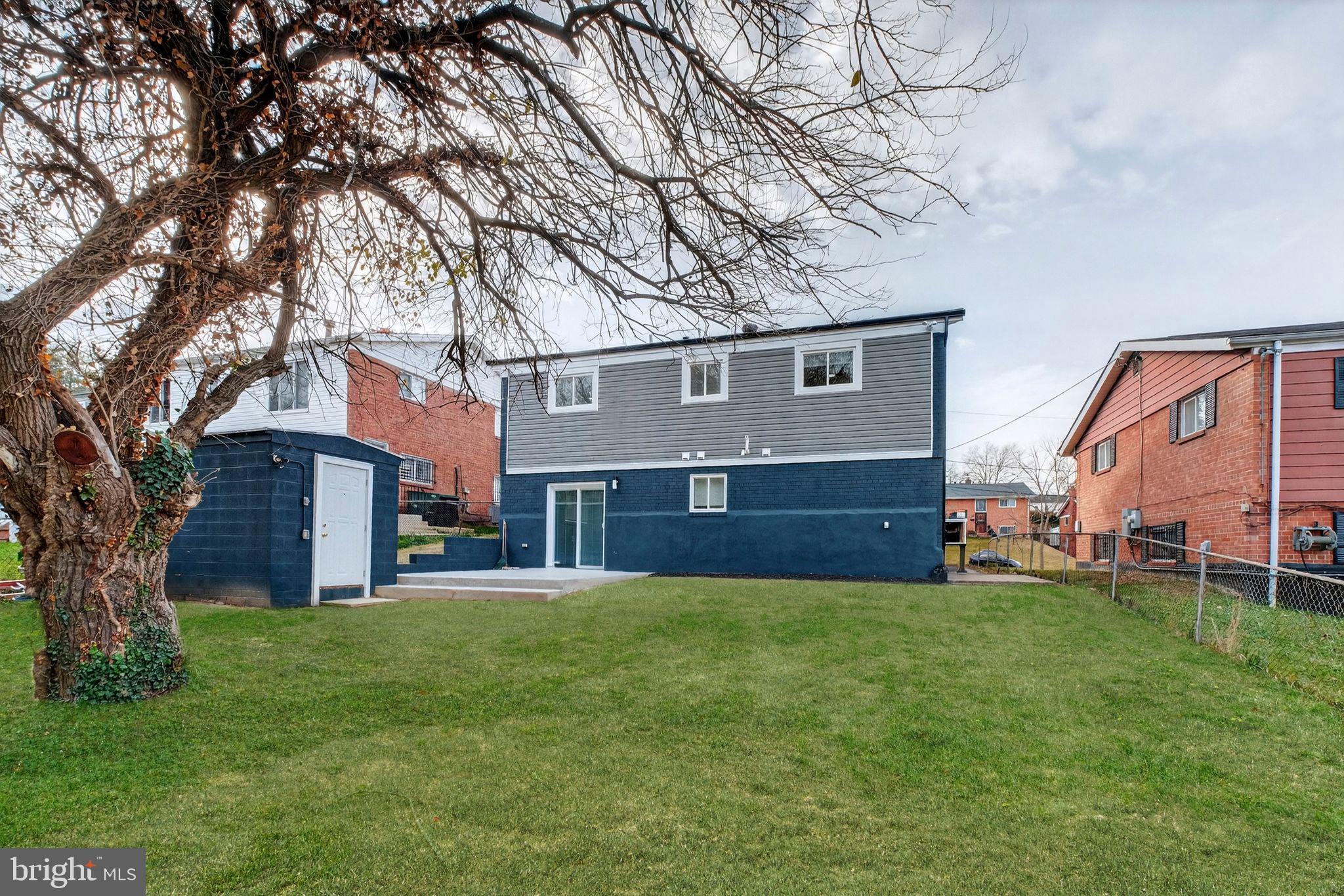 3240 Pope Street Southeast Washington, DC 20020 - Photo 38 of 38 a house that is sitting in the grass with large trees
