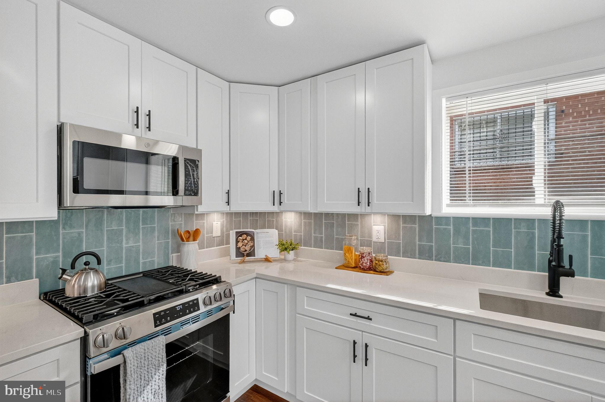 3240 Pope Street Southeast Washington, DC 20020 - Photo 9 of 38 a kitchen with stainless steel appliances granite countertop a stove a sink and a microwave