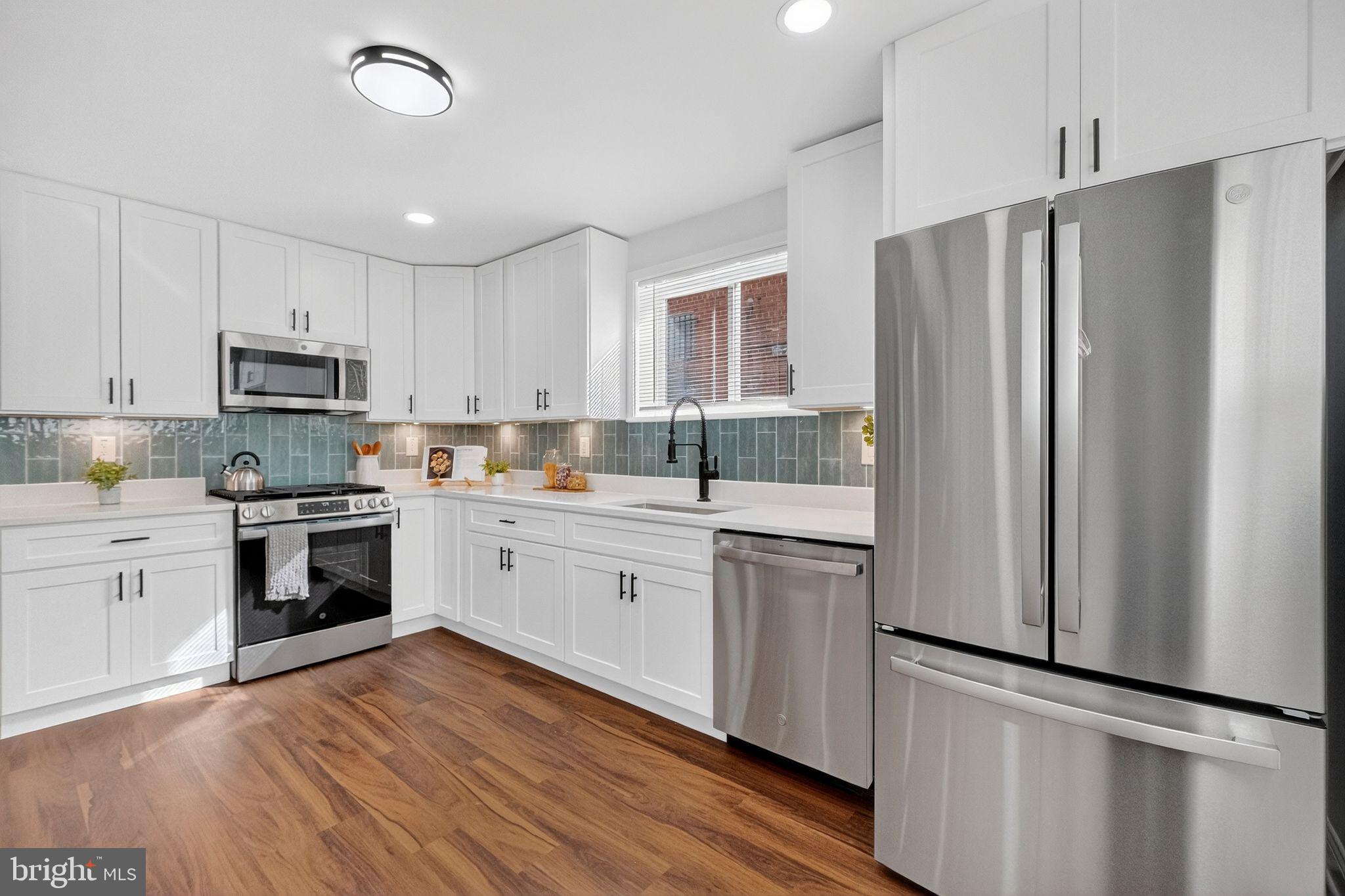 3240 Pope Street Southeast Washington, DC 20020 - Photo 10 of 40 a kitchen with stainless steel appliances a refrigerator sink and microwave