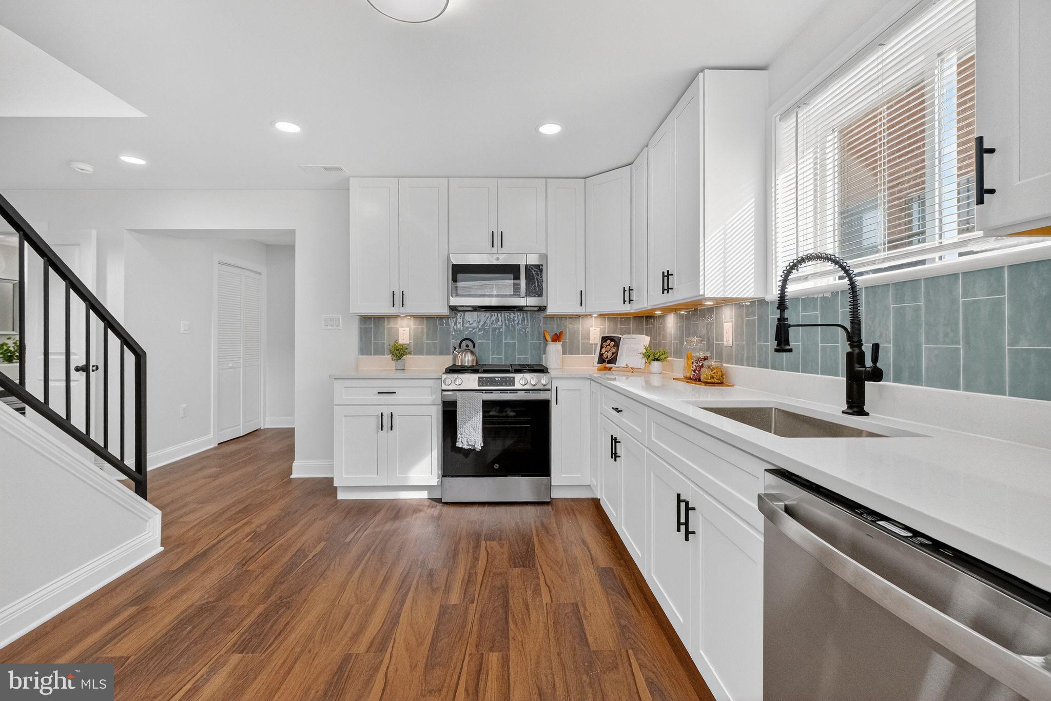 3240 Pope Street Southeast Washington, DC 20020 - Photo 10 of 38 a kitchen with granite countertop white cabinets and white appliances