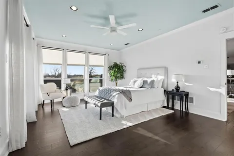 a bedroom with a bed and glass window