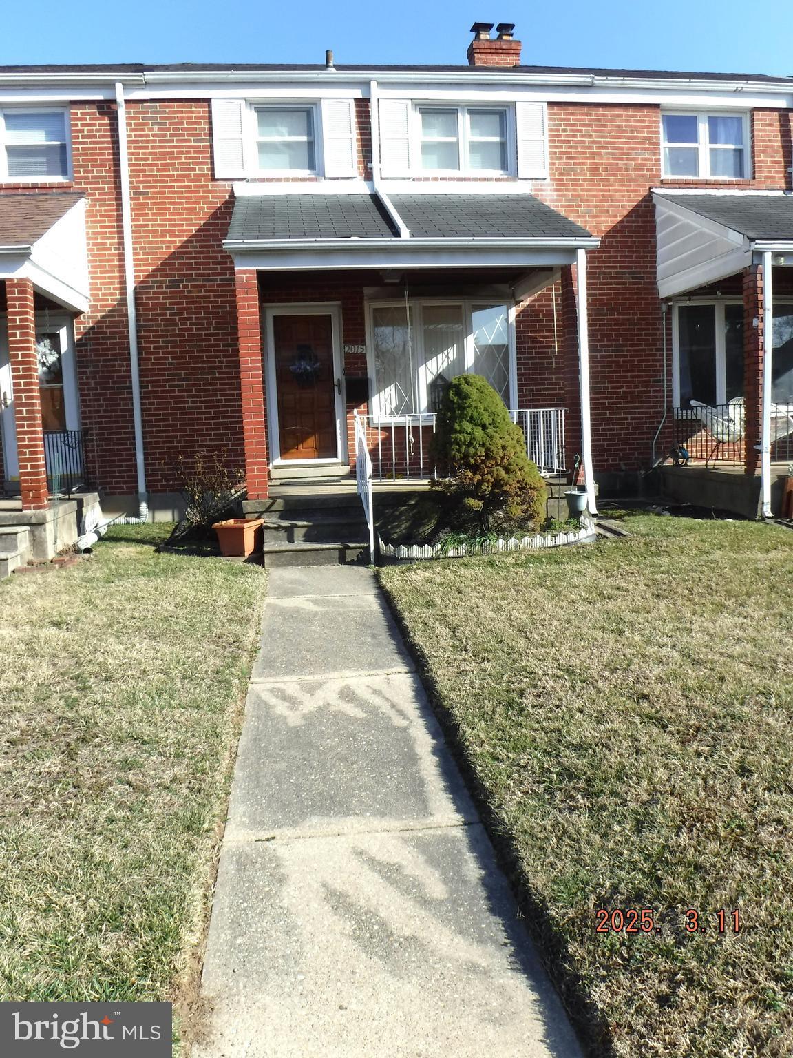 a backyard of a house with yard and outdoor seating