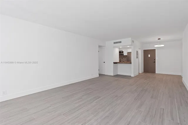 a view of a kitchen with a sink and a refrigerator