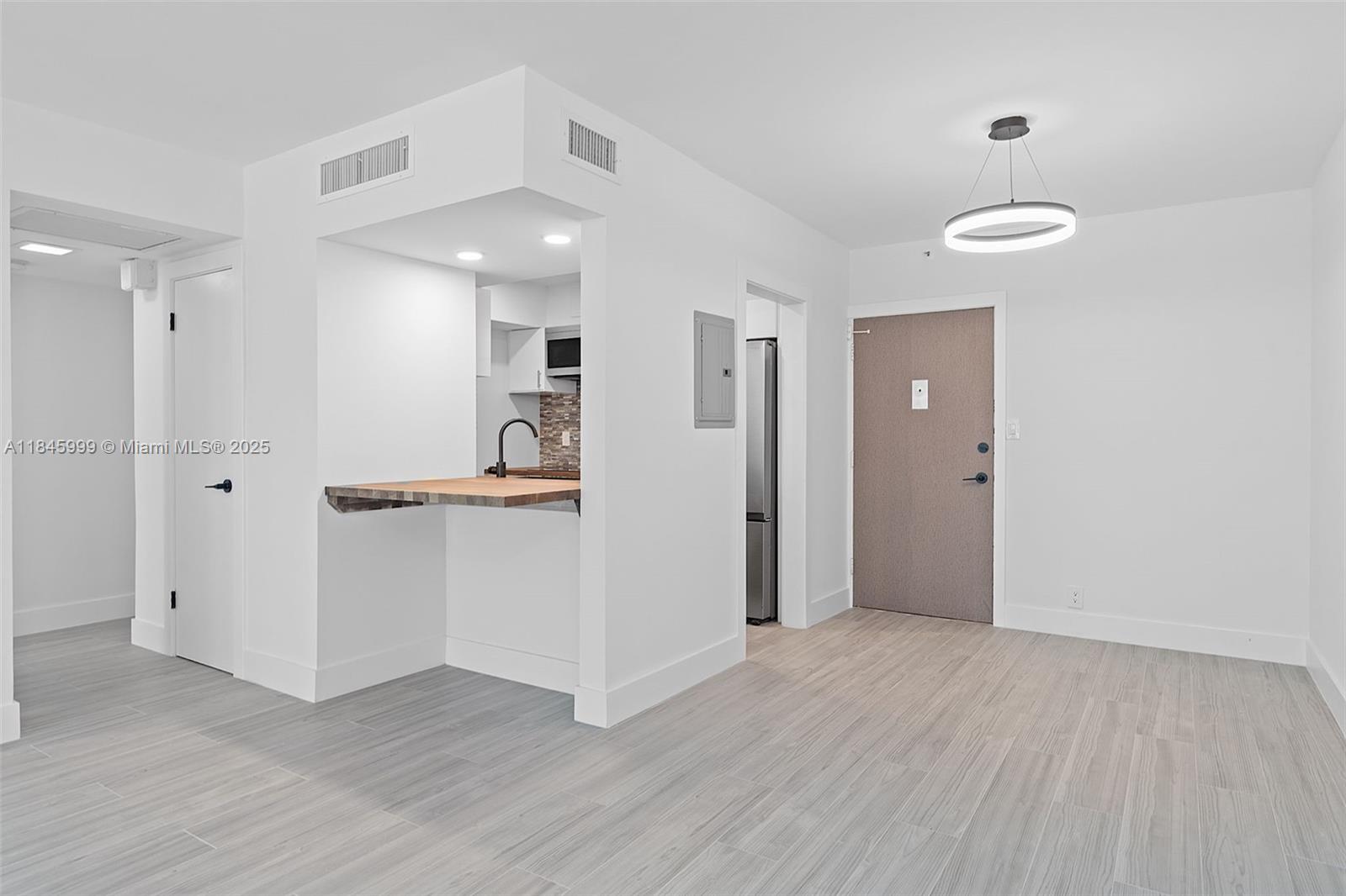 1200 West Avenue, Unit 521 Miami Beach, FL 33139 - Photo 16 of 51 a view of a kitchen with a sink and refrigerator