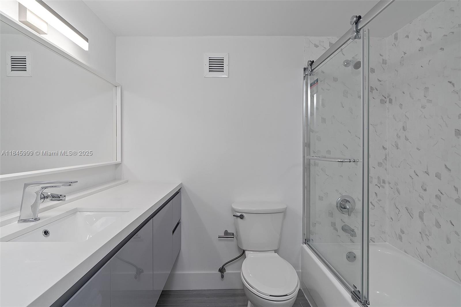 1200 West Avenue, Unit 521 Miami Beach, FL 33139 - Photo 18 of 51 a bathroom with a sink a toilet and shower