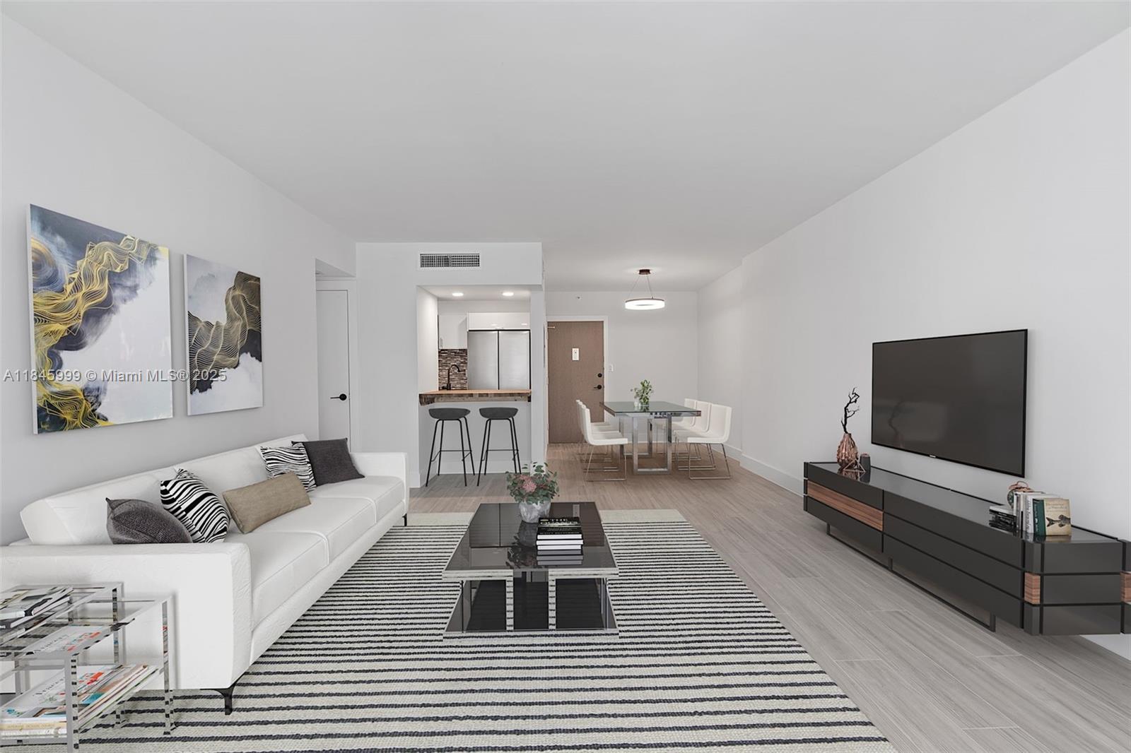 1200 West Avenue, Unit 521 Miami Beach, FL 33139 - Photo 2 of 51 a living room with furniture and a flat screen tv