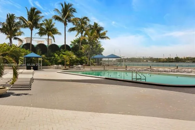 a view of a house with a swimming pool and a yard