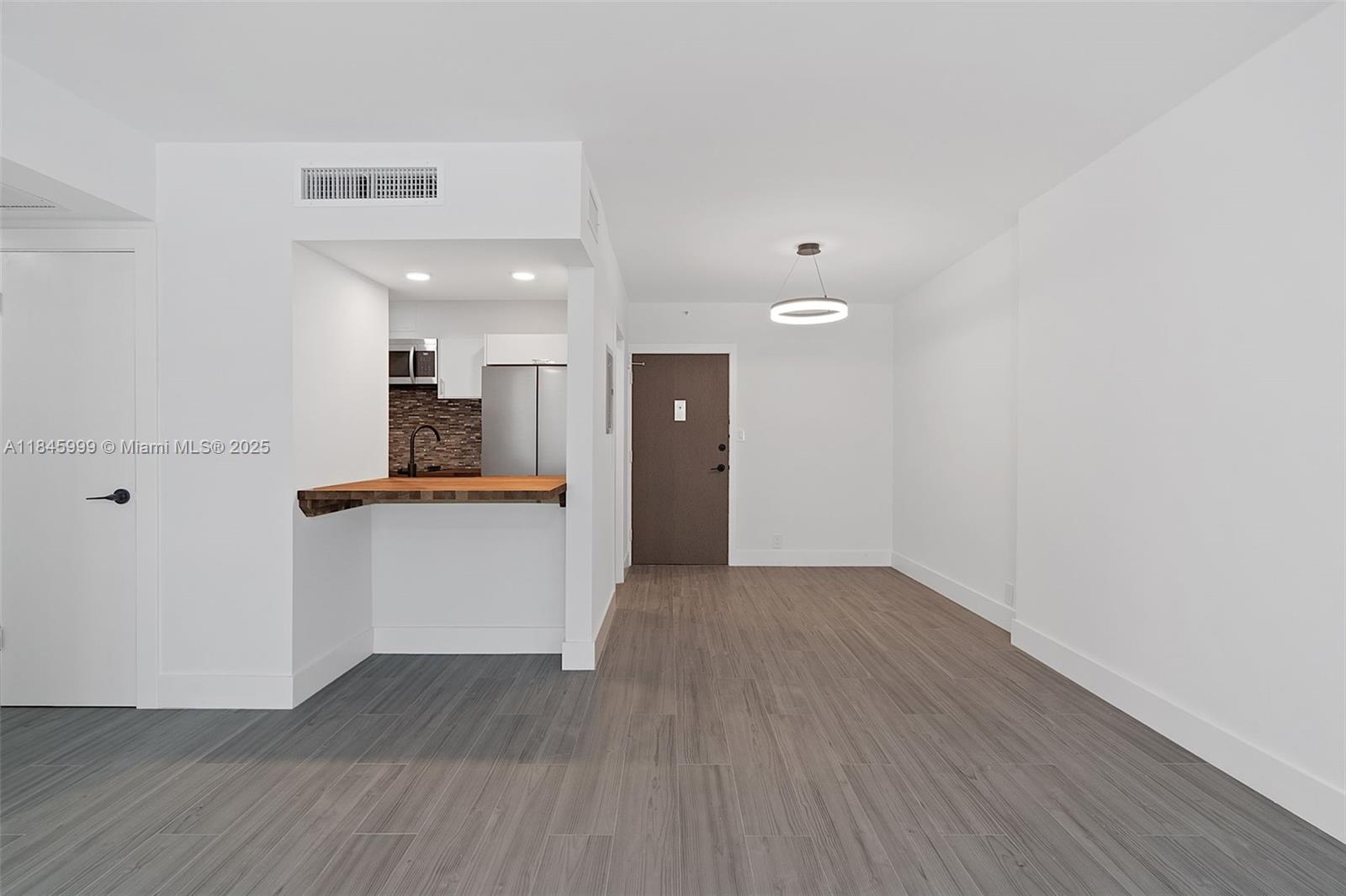 1200 West Avenue, Unit 521 Miami Beach, FL 33139 - Photo 3 of 51 a view of kitchen with wooden floor and electronic appliances