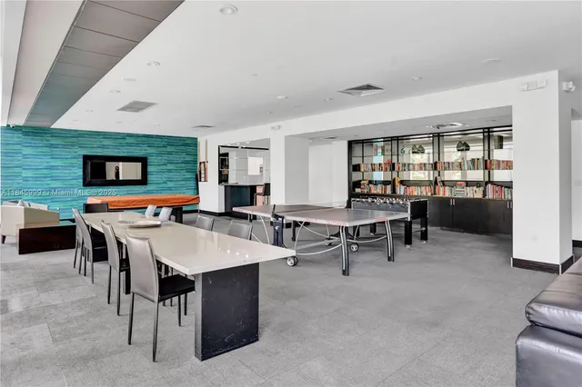 a kitchen with a table chairs sink and cabinets