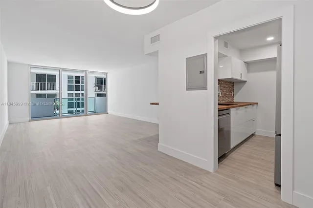 a view of a kitchen with wooden floor and a sink