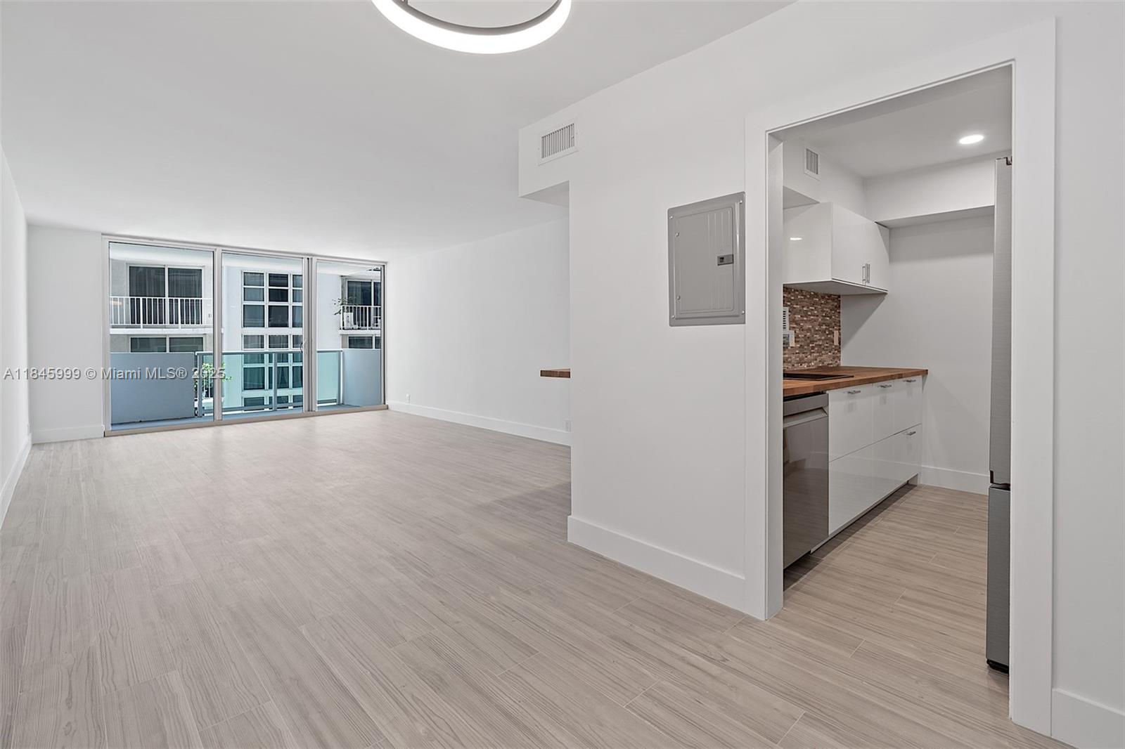 1200 West Avenue, Unit 521 Miami Beach, FL 33139 - Photo 7 of 51 a view of a kitchen with wooden floor and a sink