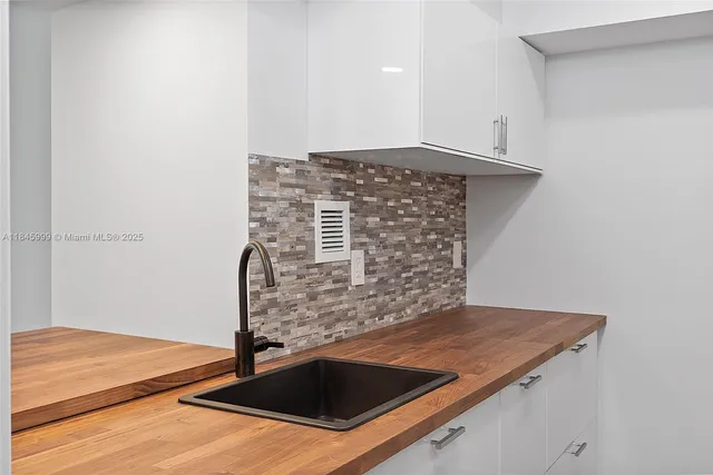 a kitchen with granite countertop a stove and a sink