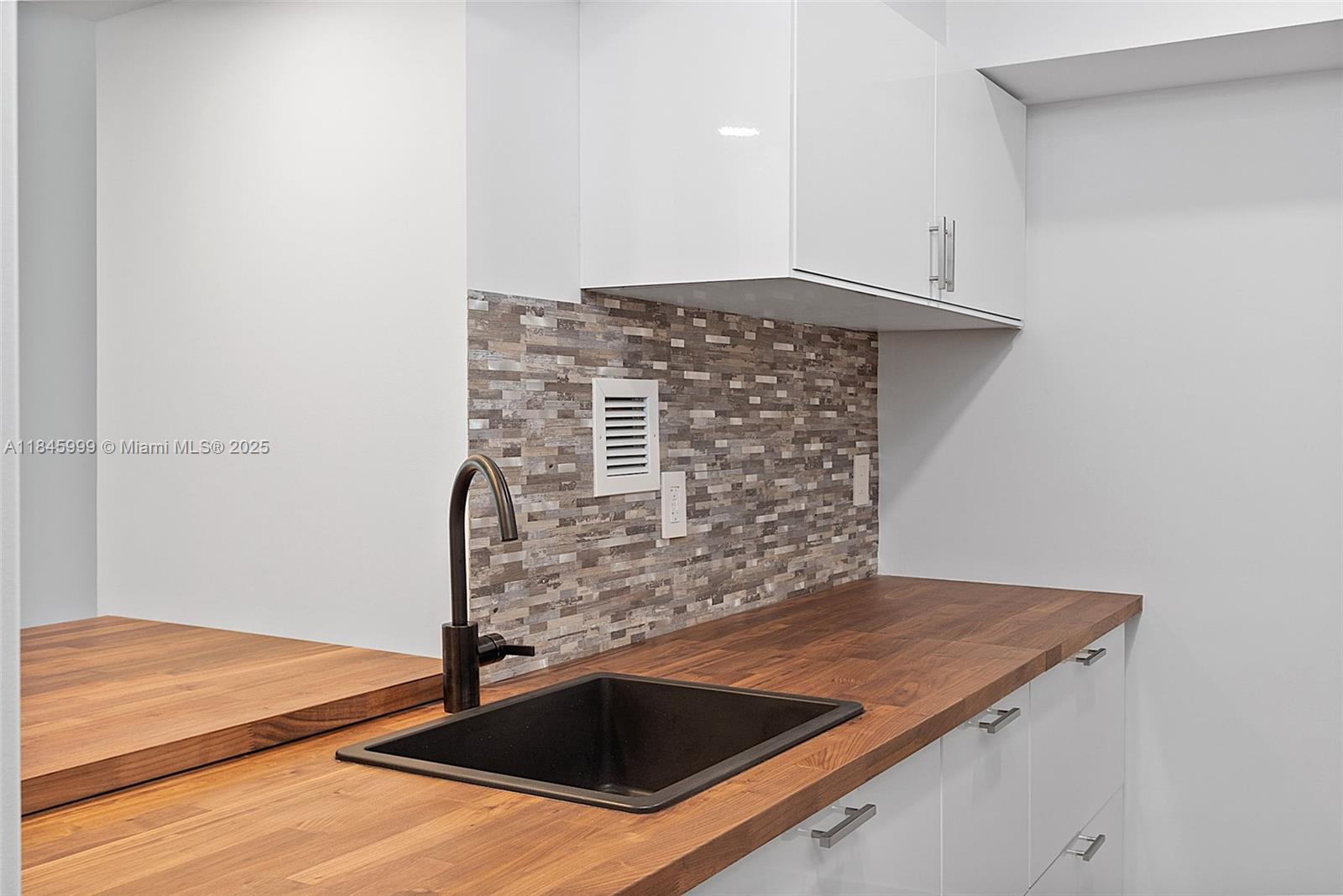 1200 West Avenue, Unit 521 Miami Beach, FL 33139 - Photo 8 of 51 a kitchen with granite countertop a stove and a sink