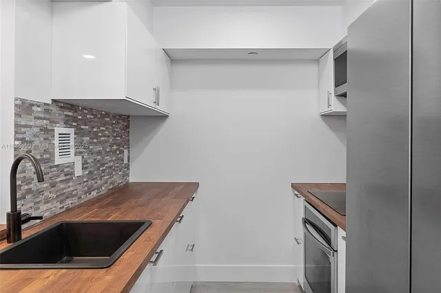 a kitchen with granite countertop a sink and a stove