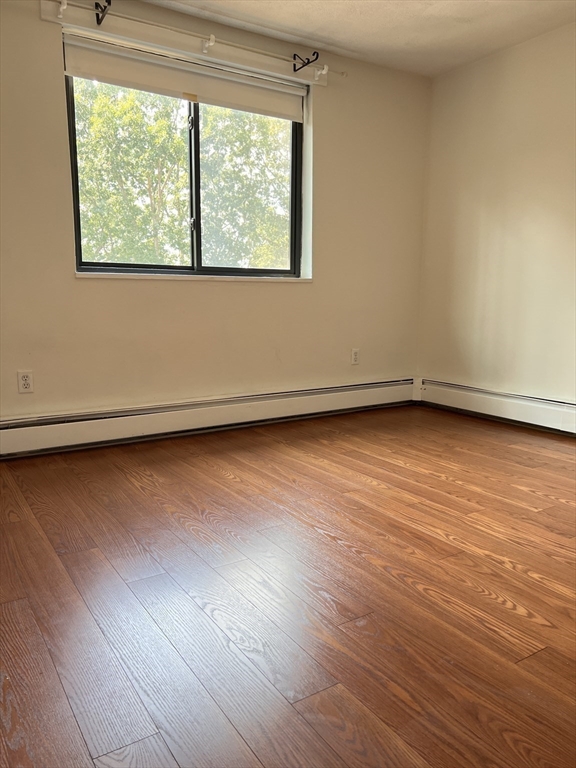 40 Colonial Drive, Unit 8 Andover, MA 01810 - Photo 13 of 19 an empty room with wooden floor and windows