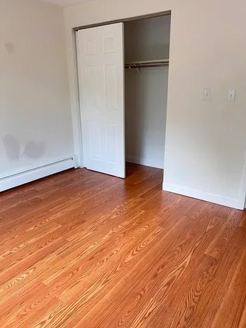 an empty room with wooden floor