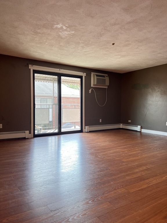 40 Colonial Drive, Unit 8 Andover, MA 01810 - Photo 5 of 19 a view of an empty room with wooden floor and a window