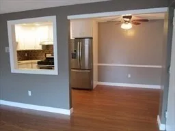 a view of a refrigerator in kitchen and wooden floor