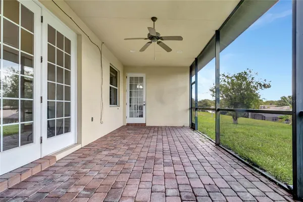 a view of a porch with a floor to ceiling windows and yard