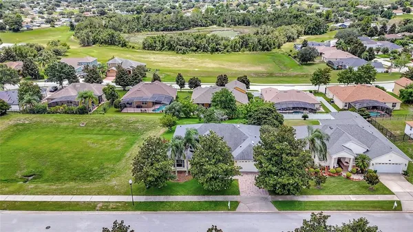 an aerial view of residential houses with outdoor space and street view