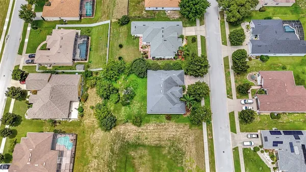 an aerial view of multiple houses with yard