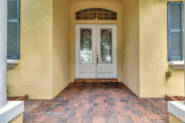 a view of a hallway with wooden floor and a living room
