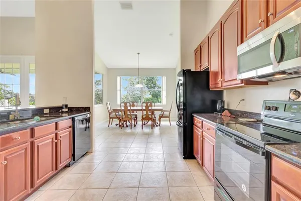 a kitchen with a stove a sink and a refrigerator