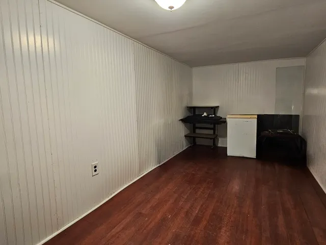 a view of a workspace with furniture and wooden floor