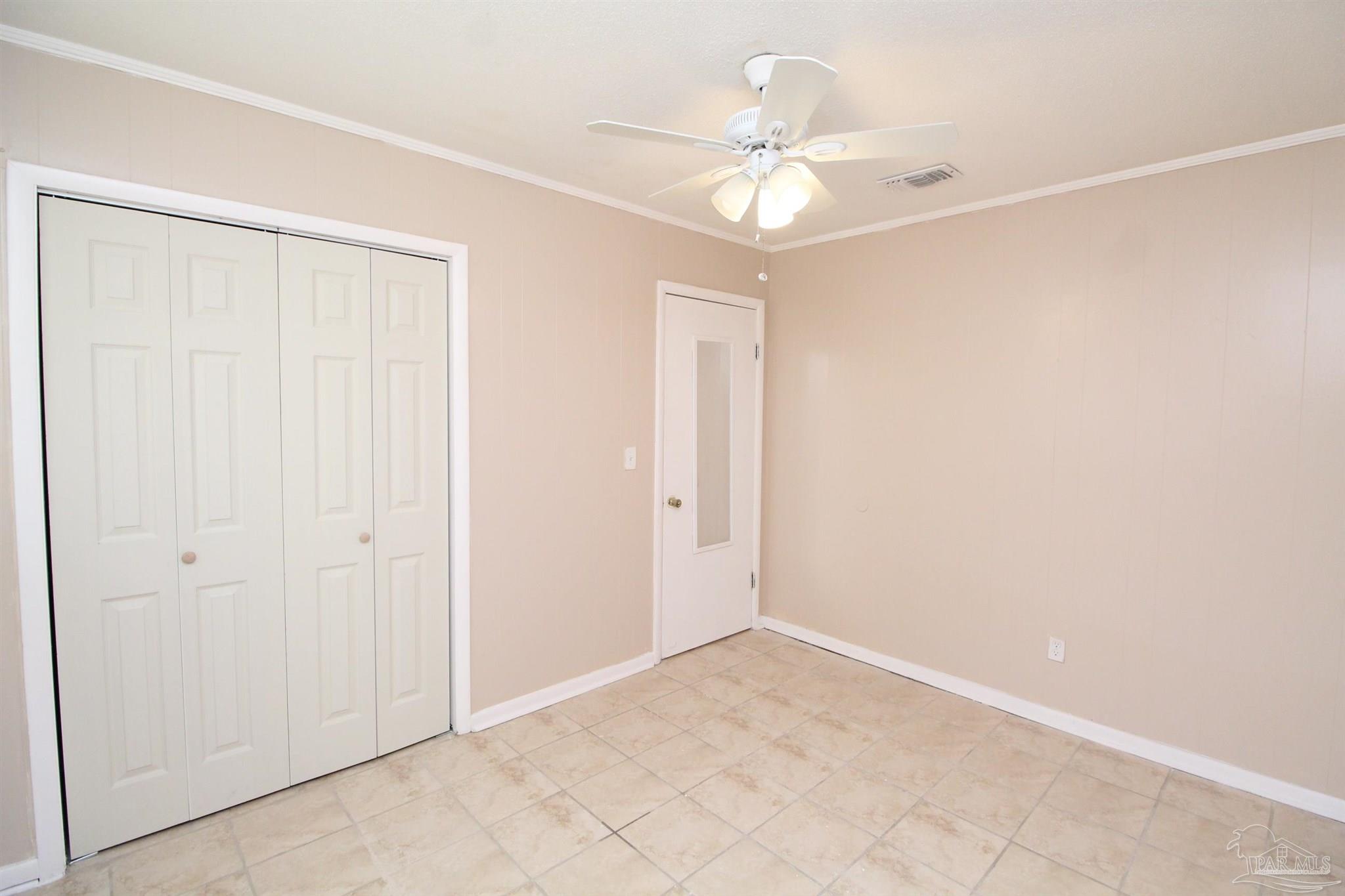 6620 Applegate Street Milton, FL 32570 - Photo 12 of 12 an empty room with a chandelier fan and closet area