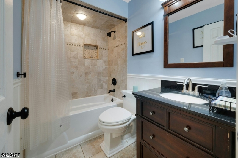 10 Ronald Terrace Springfield, NJ 07081 - Photo 20 of 36 a bathroom with a granite countertop toilet sink and mirror
