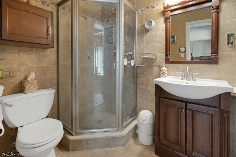 10 Ronald Terrace Springfield, NJ 07081 - Photo 31 of 36 a bathroom with a toilet a sink and shower