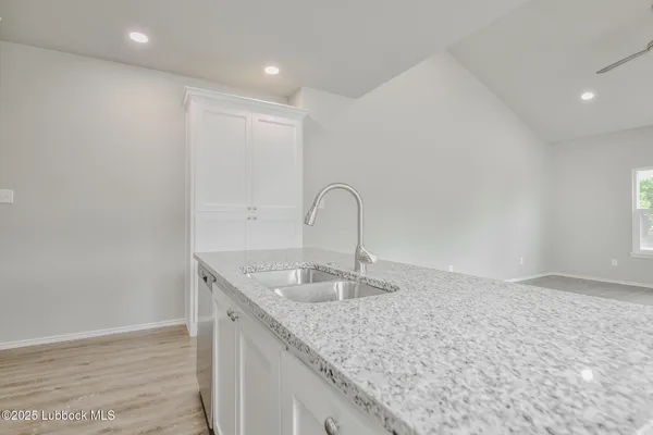 a kitchen with granite countertop a sink and a granite counter tops